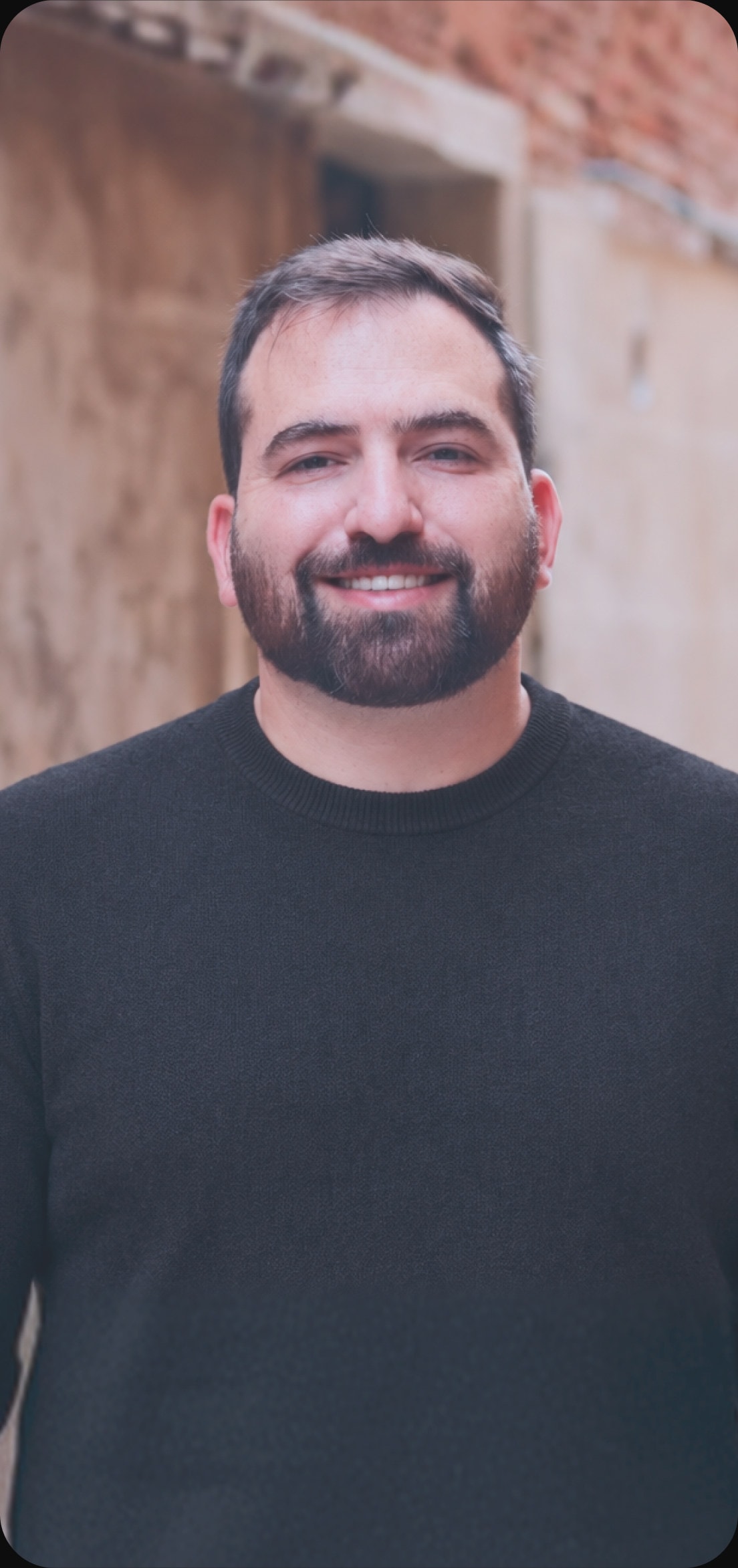 David Streshinski smiling, in a dark sweater
